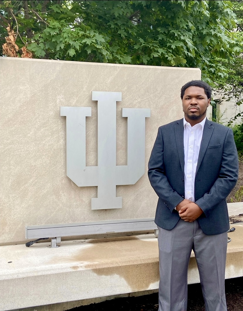 man standing in front of IU sign